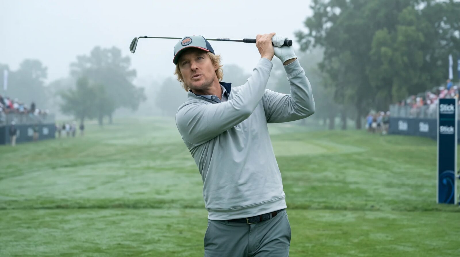 Owen Wilson as former pro golfer Pryce Cahill preparing a tee shot on a professional golf course in Stick Season 2.